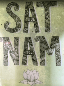 The words Sat Nam (True You) painted on the wall of the yoga retreat 