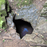 Entry to a cave is shown as just a hole in the ground