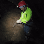 The Hostel Mom inside the cave securing her safety straps 