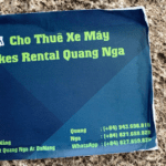 Worn business card showing the name of the motorcycle rental agent