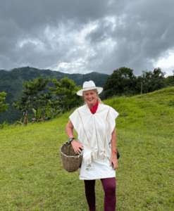 The Hostel Mom atop of a hill picking a few coffee beans in Medellin Columbia