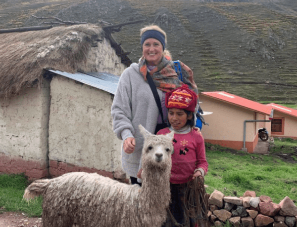 Hostel Mom with small child and Alpaca in Peru