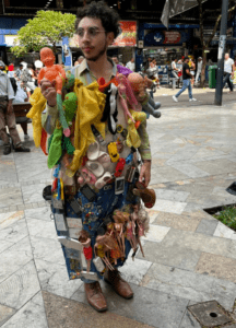 Street performer with 100 stuffed animals on his body 