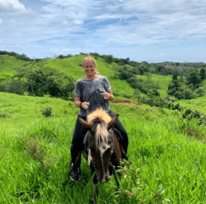 Horse and rider at the top of a hill in the Panama countryside 