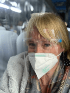 The Hostel Mom with A face mask and face shield that were required while traveling in Peru 