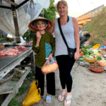 The Hostel Mom with a fresh fruit vendor in Vietnam