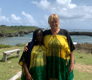 Hostel Mom and a care taker in matching Jamaican shirts 